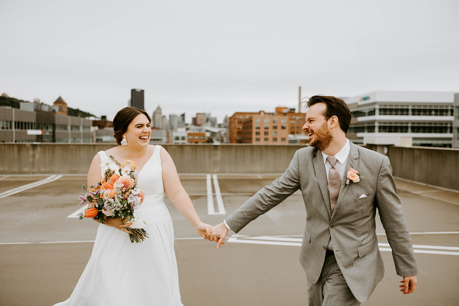 Bride and groom holding hands and smiling at each other during their wedding shoot with Lindsey Zern